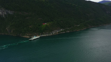 Aerial-view-around-a-ferry-docked-at-the-Liabygda-Feriekai-in-More-og-Romsdal,-Norway---circling,-drone-shot