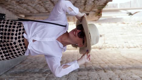 Happy-young-girl-wearing-a-straw-hat-walks-down-the-narrow-streets-of-Dubrovnik's-Old-Town