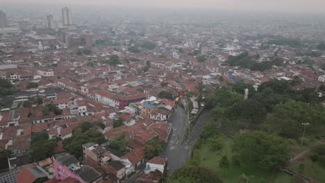Wide-aerial-footage-of-the-San-Antonio-neighborhood-on-a-rainy-foggy-morning-in-Cali,-Colombia