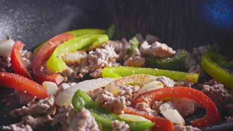 Sprinkling-Seasonings-On-Ground-Turkey-With-Bell-Pepper-And-Onion-Being-Sauteed-In-A-Pan