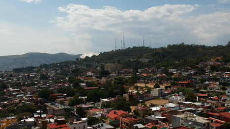Establishing-shot-of-Oaxaca-City-skyline-in-Mexico-with-mountains-and-colorful-traditional-Mexican-homes