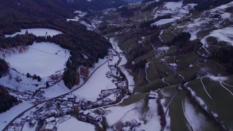 Small-town-Ranui-in-Dolomites-mountain-range-during-sunset,-winter-season
