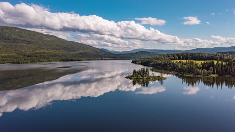 Hyperlapse-shot-of-clouds-moving-over-a-island,-on-a-reflecting-lake-in-Norway