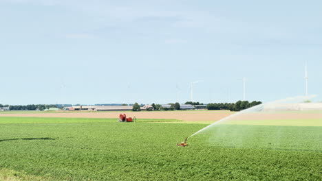 Agricultural-irrigation-system-spraying-water-over-crops,-the-Netherlands