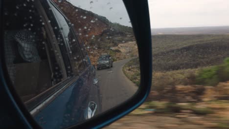 Socotra-Island,-Yemen,-24-November-2021---Two-off-road-Toyota-Landcruiser-driving-down-the-hill-in-the-rainy-day