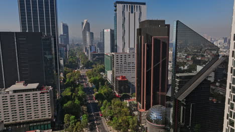 Mexico-City-Aerial-v45-low-level-flyover-wide-avenue-paseo-de-la-reforma-between-urban-and-modern-high-rise-buildings-capturing-established-downtown-cityscape---Shot-with-Mavic-3-Cine---December-2021