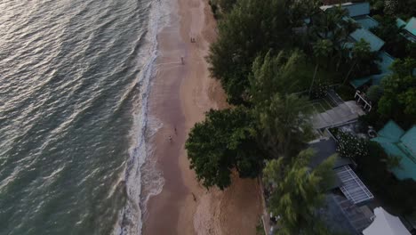 Aerial-bird's-eye-view-over-a-swimming-pool-of-a-resort-beside-Raily-beach-in-Krabi,-Thailand-during-evening-time