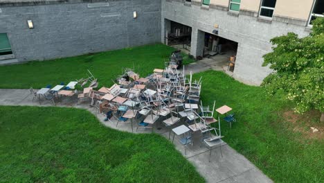 Many-desks-and-chairs-outside-of-high-school-during-summer-vacation