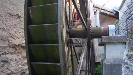 Slow-motion-shot-of-a-rotating-Wooden-Wheel-from-an-Old-Water-Mill-in-Meersburg,-Germany
