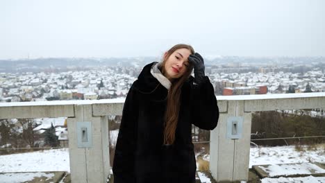 Beautiful-female-model-posing-in-front-of-a-city-in-the-winter-time
