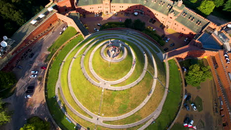 Aerial-top-down-shot-of-KoÅ›ciuszko-Hill-in-Cracow,-many-tourist-visiting-famous-destination-at-sunset
