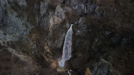 Waterfall-flowing-into-rocky-cliffs-of-mountain