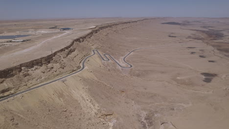 View-of-a-beautiful-dry-desert-area-with-a-winding-road-rising-out-of-a-crater