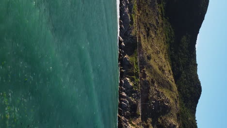 VERTICAL-marine-ocean-pollution-drone-aerial-view-of-sea-water-with-floating-trash-garbage