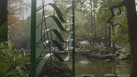 A-lush-green-park-with-a-lake-and-a-music-note-installation