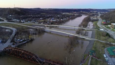 Aerial-landscape-of-Frankfort-Kentucky-traffic-and-cars-crossing-the-bridge-along-the-river-at-sunset