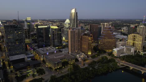 Aerial-view-of-the-Austin-city-center-with-evening-lights,-in-Texas,-USA---tracking,-drone-shot