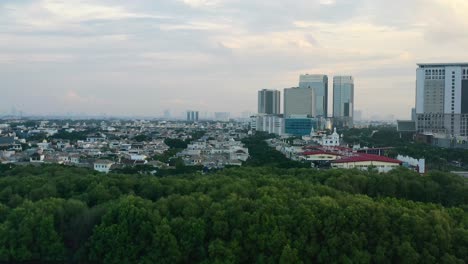 Aerial-pan-left-of-metropolitan-area-of-PIK-in-Jakarta-Indonesia-at-sunset-with-modern-eco-buildings