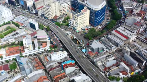 Light-traffic-with-cars-and-motorbikes-on-highway-road-in-Kota-Tua-Jakarta,-aerial