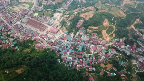 An-aerial-shot-pushes-forward-and-tilts-down-towards-Sapa-Vietnam-above-the-forest