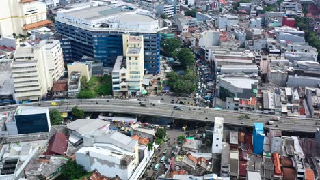 Heavy-traffic-in-the-streets-and-highway-of-Kota-Tua-Jakarta-Indonesia,-aerial