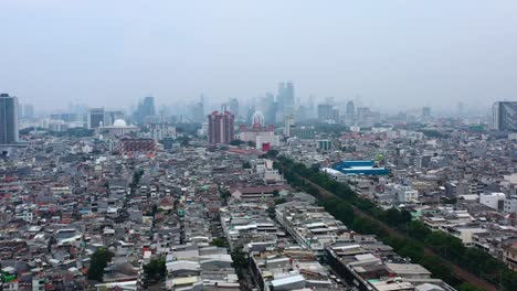 Polluted-air-skyline-of-Jakarta-Indonesia-with-dense-population-and-homes,-aerial