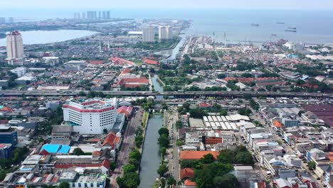 Aerial-cityscape-view-of-the-ocean-and-Kota-Tua-in-North-Jakarta-on-sunny-day