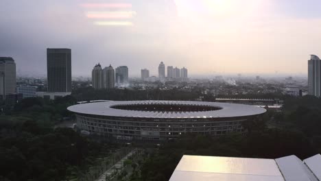 Destello-De-Luz-Aérea-De-La-Puesta-De-Sol-Sobre-El-Complejo-Deportivo-Gbk-Y-El-Estadio-Sobre-El-Horizonte-De-Jakarta