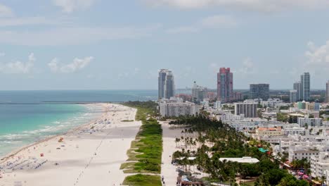 Tropical-beach-and-skyline-of-Miami-city,-high-altitude-aerial-view