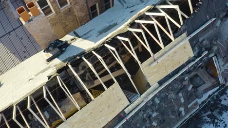 Aerial-drone-bird's-eye-view-of-burnt-roof-structure-of-a-house-pn-a-sunny-day