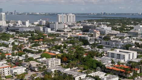 Tropical-living-buildings-and-palm-trees-of-Miami,-aerial-drone-view