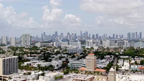Miami-city-skyline-with-suburbs-in-foreground,-aerial-cinematic-view