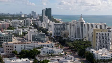Exotic-cityscape-of-Miami-downtown-with-Atlantic-ocean-behind,-aerial-orbit