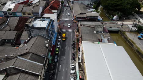 Phuket-Thailand:-Aerial-drone-forward-moving-shot-over-a-main-road-passing-through-an-old-town-in-phuket-at-daytime