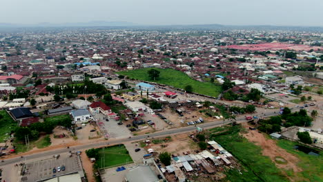 The-populated-Gwagwalada-area-of-Abuja,-Nigeria-on-a-smoggy-day---aerial-flyover