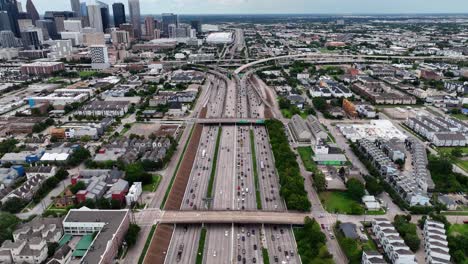 Aerial-view-of-traffic-on-the-Gulf-Fwy,-Interstate-45-and-10,-in-Houston,-USA---tilt,-drone-shot