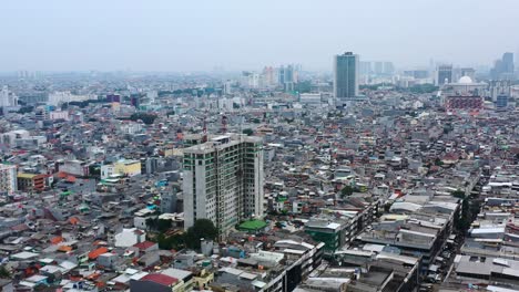 Crammed-homes-and-buildings-in-dense-population-of-Jakarta-Indonesia,-aerial