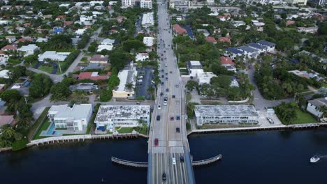 Palmetto-Park-Rd-ICW-Bridge-with-Busy-Traffic-on-the-East-Coast-of-Florida-from-an-Aerial-Drone-Tilting-Upward-Revealing-the-Scenic-Coastline-View-of-the-Ocean