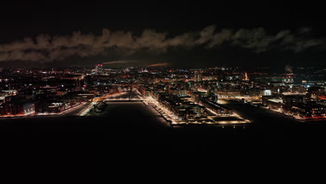 Aerial-view-of-apartment-buildings-and-factories-in-Jätkäsaari,-Helsinki-by-night