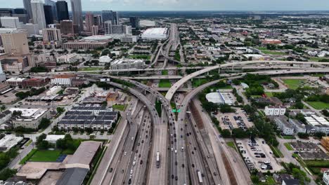Aerial-view-over-traffic-on-a-large-stack-interchange,-in-Houston,-USA