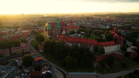 Aerial-view-Cracow-sunrise-cityscape-skyline-push-in-towards-Wawel-castle-old-town-towers