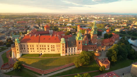 Aerial-view-Cracow-old-town-green-domed-cathedral-towers-Wawel-castle-Poland-pull-away-shot