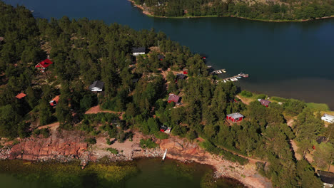 Aerial-view-of-houses-on-a-island-in-sunny-Degersand,-Aland---tracking,-drone-shot