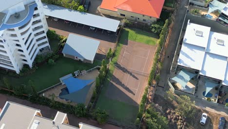 Drone-shot-of-tennis-court-and-swimming-pool-in-an-apartment-complex