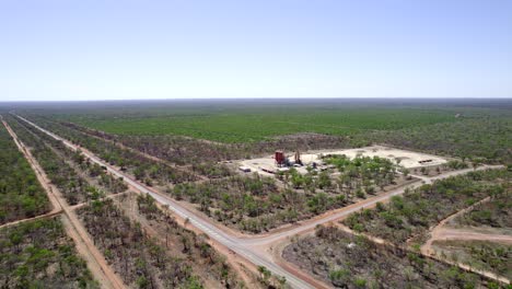 High-drone-shot-of-a-rural-highway-intersection-next-to-a-field-of-sandalwood-trees