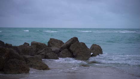 Waves-hitting-hard-the-rocks-on-the-beach-before-the-storm-in-Miami-4k