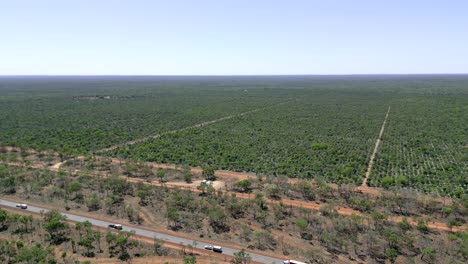 Drone-shots-of-caravans-and-a-truck-driving-on-a-rural-highway-in-outback-Australia