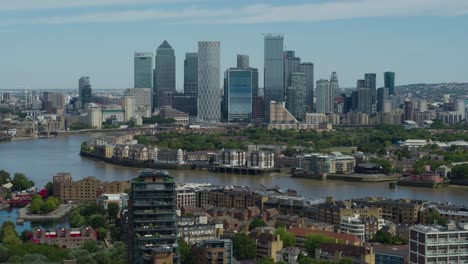 Aerial-establishing-shot-of-Canary-wharf-featuring-the-river-Thames-and-London-Skyline