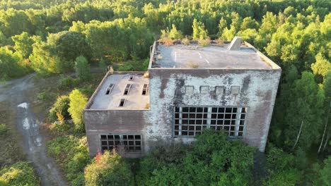 Drone-gradually-rising-in-front-of-a-disused-coal-mining-building