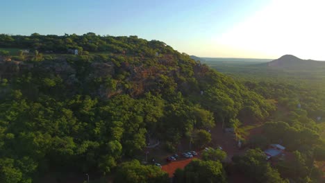 Aerial-drone-backward-moving-shot-of-Cerro-Yaguaron-which-is-mound-located-in-Paraguay,-South-America-during-evening-time